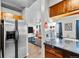 Modern kitchen with stainless steel refrigerator and open view into living room at 1150 Inca St # 25, Denver, CO 80204