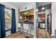 Compact kitchen featuring a breakfast bar, stainless steel appliances, and unique decor at 1150 Inca St # 25, Denver, CO 80204