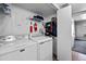 Functional laundry room with washer, dryer, and shelving for storage and organization at 1150 Inca St # 25, Denver, CO 80204