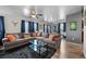 Comfortable living room featuring a large sectional sofa, glass coffee table, and hardwood floors at 1150 Inca St # 25, Denver, CO 80204