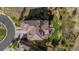 An aerial view shows a landscaped property featuring a red-tiled roof, solar panels and a green lawn at 1240 Starglow Pl, Highlands Ranch, CO 80126