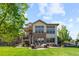 A beautifully landscaped backyard featuring a stone patio with seating, a lawn and stone accents at 1240 Starglow Pl, Highlands Ranch, CO 80126