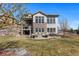 Stunning home's backyard with a patio and an outdoor seating area for relaxing and entertaining at 1240 Starglow Pl, Highlands Ranch, CO 80126