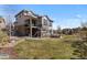 Large backyard with patio seating, a well-manicured lawn, and an exterior view of the home at 1240 Starglow Pl, Highlands Ranch, CO 80126