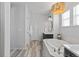 Elegant bathroom featuring a soaking tub, wood tile flooring, and updated fixtures at 1240 Starglow Pl, Highlands Ranch, CO 80126