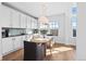 Cozy dining space with modern lighting and a view of the yard from the window at 1240 Starglow Pl, Highlands Ranch, CO 80126