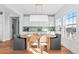 Bright dining room with natural light and a modern light fixture at 1240 Starglow Pl, Highlands Ranch, CO 80126
