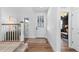 Bright foyer with hardwood floors, a front door with decorative glass, and a view into the home at 1240 Starglow Pl, Highlands Ranch, CO 80126