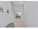 Hallway with carpet leading to stairs and featuring bench and console table at 1240 Starglow Pl, Highlands Ranch, CO 80126