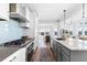 Bright kitchen features stainless steel appliances, island with sink, and an open floor plan at 1240 Starglow Pl, Highlands Ranch, CO 80126
