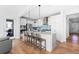 Bright kitchen with stainless steel appliances, a large island, and stylish barstool seating at 1240 Starglow Pl, Highlands Ranch, CO 80126