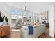 Bright living room featuring hardwood floors, stylish seating, fireplace and large windows with neighborhood views at 1240 Starglow Pl, Highlands Ranch, CO 80126