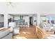 Open-concept living area with hardwood floors and views of the open kitchen with counter seating at 1240 Starglow Pl, Highlands Ranch, CO 80126