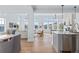 Open-concept living area with hardwood floors and neutral decor, flooded with natural light at 1240 Starglow Pl, Highlands Ranch, CO 80126