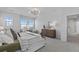 Bright main bedroom has a dresser, side tables, and sitting area at 1240 Starglow Pl, Highlands Ranch, CO 80126