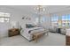 The main bedroom is bright with many windows, and has a king bed at 1240 Starglow Pl, Highlands Ranch, CO 80126