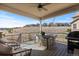 Cozy covered outdoor patio with dining and lounge seating overlooking the valley at 1240 Starglow Pl, Highlands Ranch, CO 80126