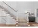 Elegant staircase with hardwood floors, white wainscoting and decorative carpet on the steps at 1240 Starglow Pl, Highlands Ranch, CO 80126