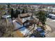 Aerial view of a home featuring a two-car garage, fenced yard, and mature trees at 5894 S Oak St, Littleton, CO 80127