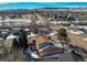An aerial shot shows a home with a deck near an intersection with mountain views at 5894 S Oak St, Littleton, CO 80127