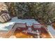 A wooden back deck overlooks a partially snow covered yard with several mature trees and a storage shed at 5894 S Oak St, Littleton, CO 80127