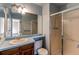 Bathroom featuring a vanity with sink, mirror and a glass shower door at 5894 S Oak St, Littleton, CO 80127