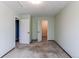 Neutral carpeted bedroom with two doors and space for personalization at 5894 S Oak St, Littleton, CO 80127