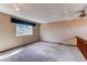A carpeted bedroom featuring a ceiling fan, large window with blue valance, and wood railing at 5894 S Oak St, Littleton, CO 80127