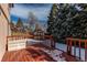 An inviting deck area with railing and some snow, ideal for outdoor gatherings at 5894 S Oak St, Littleton, CO 80127