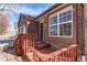 Inviting front entrance with brick and shingle details plus a small front porch at 5894 S Oak St, Littleton, CO 80127