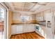 Well-lit kitchen with white appliances, ample counter space, and a view to the outdoors at 5894 S Oak St, Littleton, CO 80127