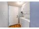Functional laundry room with a washer, a dryer, a utility sink, and wood-look flooring at 5894 S Oak St, Littleton, CO 80127