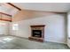Bright living room with a brick fireplace, a large window, and vaulted ceilings at 5894 S Oak St, Littleton, CO 80127