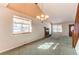 Open living room featuring a brick fireplace, large windows, and an entry door at 5894 S Oak St, Littleton, CO 80127