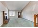 Cozy living room featuring a brick fireplace, an entry door, and a large window at 5894 S Oak St, Littleton, CO 80127