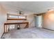 An open living room with exposed beam, lots of natural light and entry to other rooms at 5894 S Oak St, Littleton, CO 80127