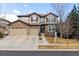 Charming two-story home featuring a stone facade, three-car garage, and attractive curb appeal at 24612 E Ontario Dr, Aurora, CO 80016