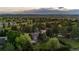Majestic aerial perspective of home in a tranquil setting, embraced by lush greenery, mature trees and open skies at 7398 E Windlawn Way, Parker, CO 80134