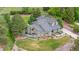 Aerial view of a beautifully landscaped home with mature trees, a well-maintained lawn and large lot at 7398 E Windlawn Way, Parker, CO 80134