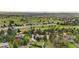 Expansive aerial view of a neighborhood showcasing mature trees, lush greenery, and a sprawling golf course at 7398 E Windlawn Way, Parker, CO 80134