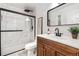 Modern bathroom with a glass-enclosed shower, vanity, and decorative accents at 7398 E Windlawn Way, Parker, CO 80134