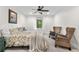 Comfortable bedroom with carpeted floors, ceiling fan, and sunny window views at 7398 E Windlawn Way, Parker, CO 80134