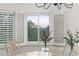 Bright dining area with white shuttered windows and botanical decor overlooking a beautiful view at 7398 E Windlawn Way, Parker, CO 80134