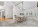 Bright dining room with a vaulted ceiling, modern chandelier and windows with shutters allowing natural light to illuminate the room at 7398 E Windlawn Way, Parker, CO 80134