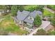 A beautiful home boasts lush landscaping, mature trees, and a well-manicured lawn at 7398 E Windlawn Way, Parker, CO 80134