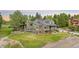 Charming home featuring an elevated deck, mature trees, and manicured lawn, set on a beautiful lot at 7398 E Windlawn Way, Parker, CO 80134