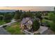 Charming exterior showcasing a well-maintained lawn, mature trees, and a welcoming facade with warm, inviting lighting at 7398 E Windlawn Way, Parker, CO 80134
