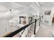 Bright foyer featuring a staircase with black handrails and hardwood flooring, leading to a cozy living area at 7398 E Windlawn Way, Parker, CO 80134