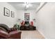 Relaxing den featuring carpet floors, natural light, and a cozy leather sitting chair at 7398 E Windlawn Way, Parker, CO 80134