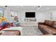 Finished basement living area with a large television and comfortable leather seating at 7398 E Windlawn Way, Parker, CO 80134